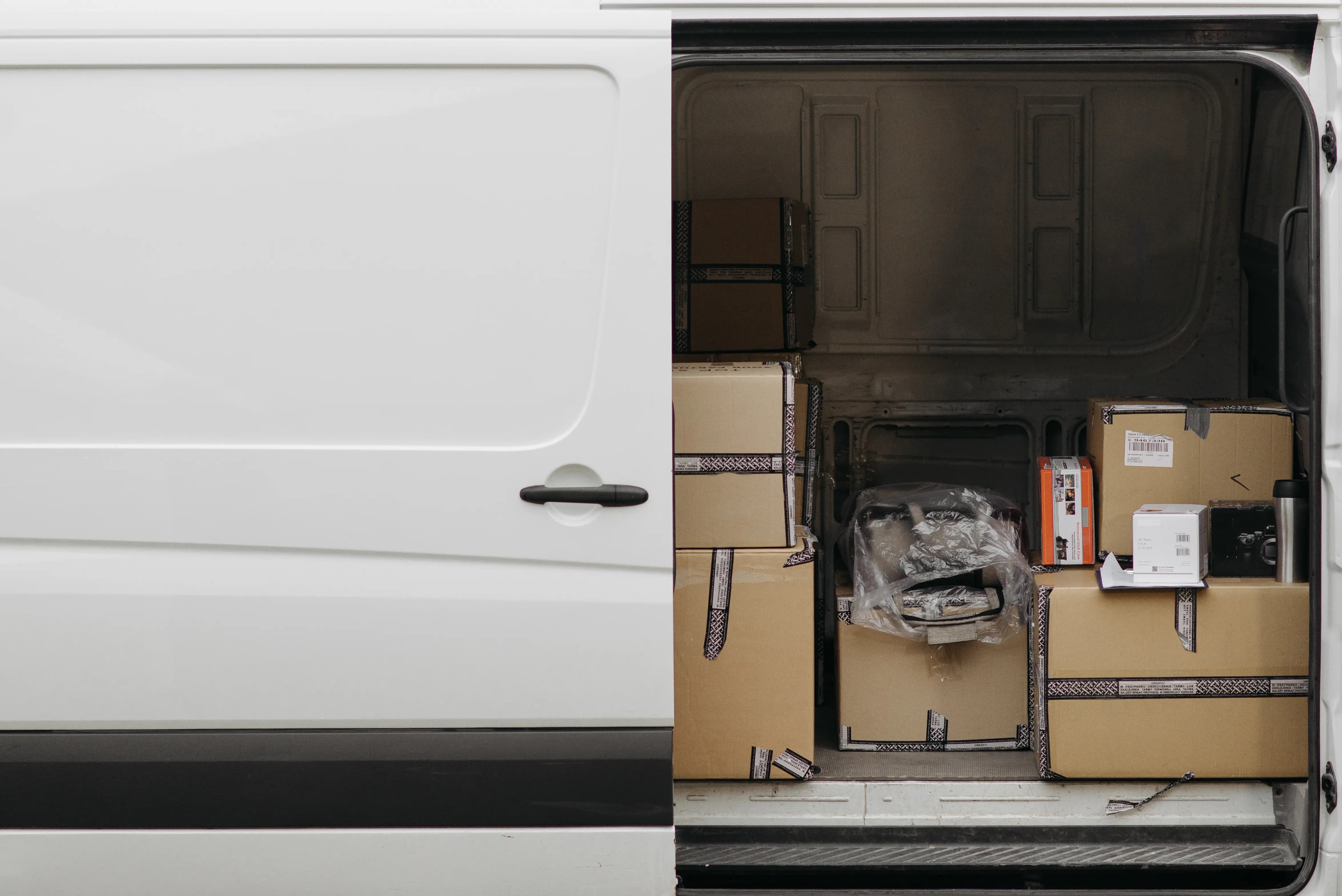 Courier delivery van loaded with parcels for fast international shipping from Nigeria